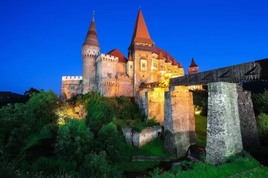 Beautiful night panorama of the Hunyad Castle / Corvins Castle with wooden bridge.